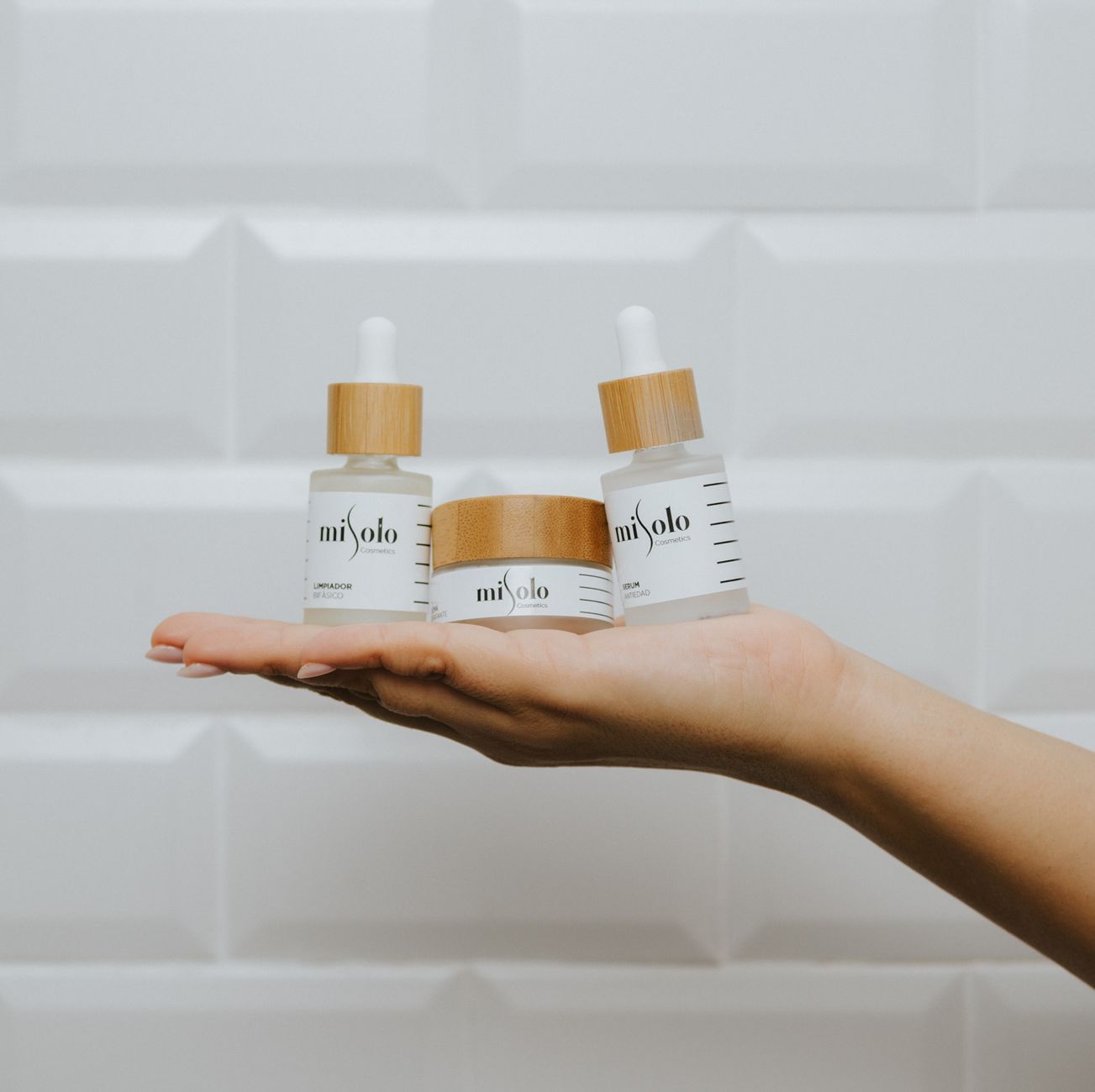 close up of hand holding beauty products